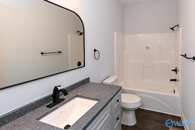 full bathroom featuring shower / tub combination, vanity, hardwood / wood-style flooring, and toilet