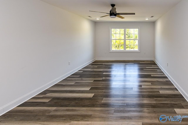 empty room with ceiling fan and dark wood-type flooring