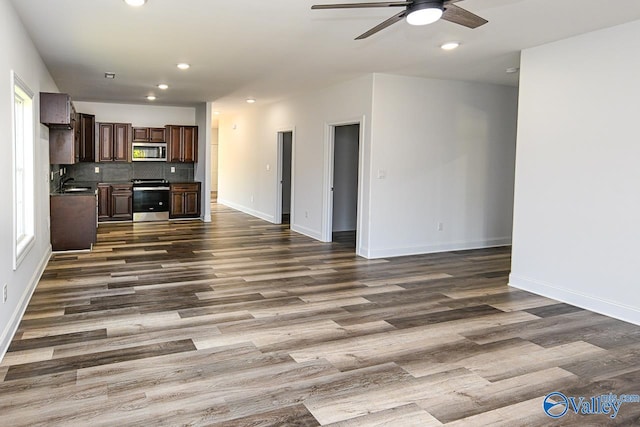 kitchen with dark hardwood / wood-style flooring, stainless steel appliances, and plenty of natural light