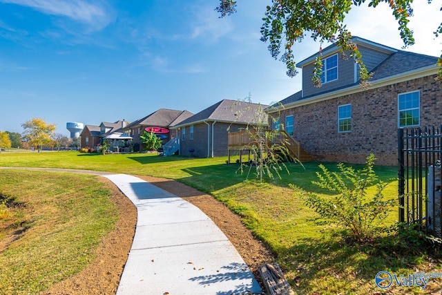 view of property's community with a wooden deck and a yard