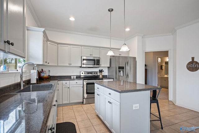 kitchen featuring sink, a center island, hanging light fixtures, light tile patterned floors, and appliances with stainless steel finishes