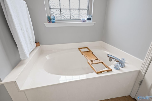 bathroom featuring a washtub and tile patterned floors