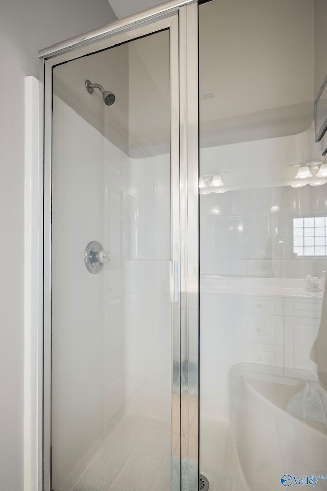 bathroom with a shower with shower door