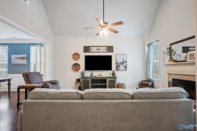 living room featuring decorative columns, high vaulted ceiling, dark hardwood / wood-style floors, and ceiling fan