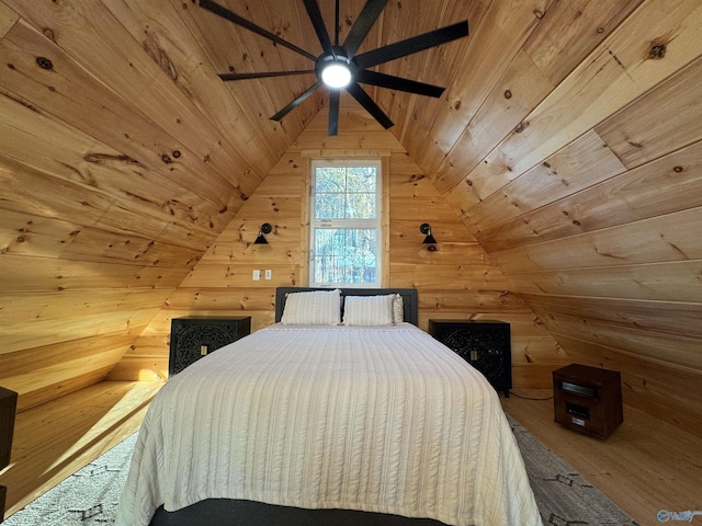 unfurnished bedroom featuring lofted ceiling, wood ceiling, ceiling fan, wood walls, and hardwood / wood-style flooring