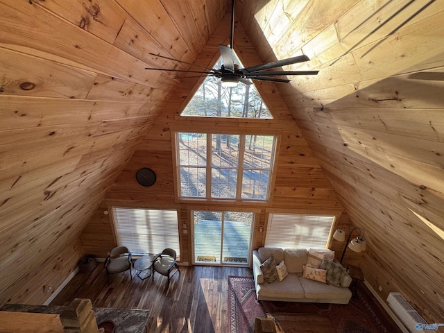 additional living space featuring ceiling fan, hardwood / wood-style flooring, wood walls, and wooden ceiling