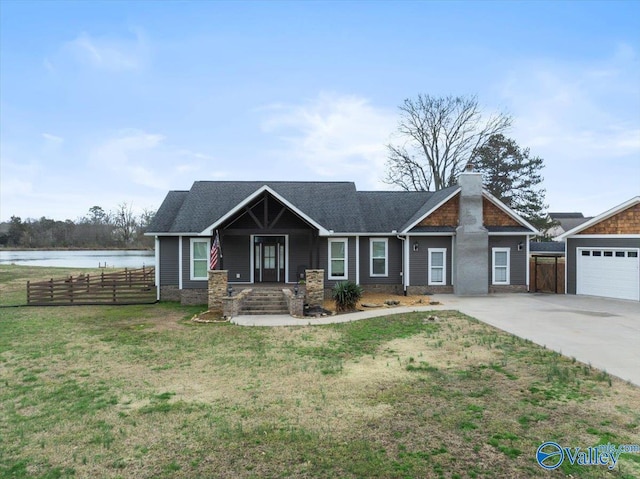 view of front of house with fence, concrete driveway, a front yard, a garage, and a chimney