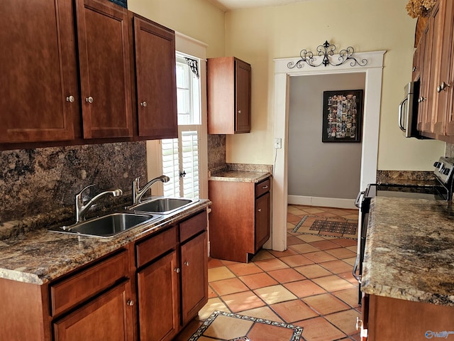 kitchen featuring sink, appliances with stainless steel finishes, tasteful backsplash, and light tile patterned flooring