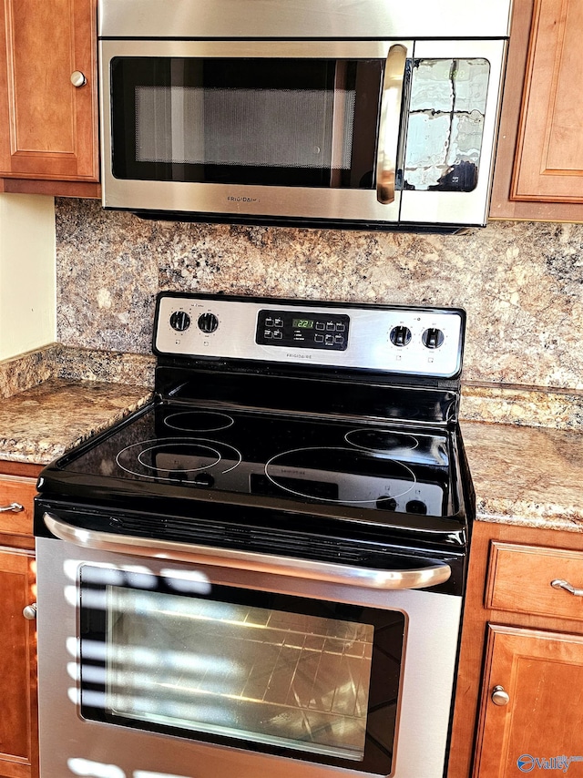 kitchen with decorative backsplash, light stone counters, and stainless steel appliances