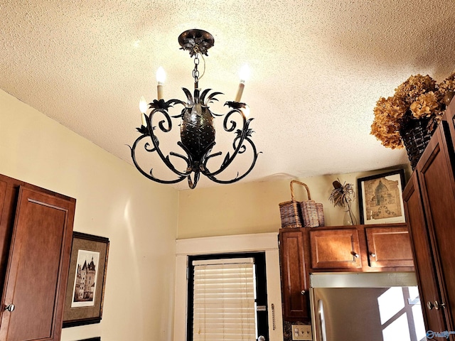 room details with a textured ceiling and refrigerator