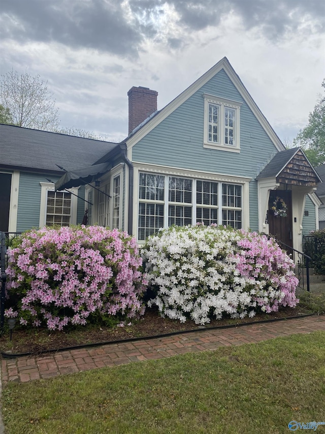 view of side of property with a yard