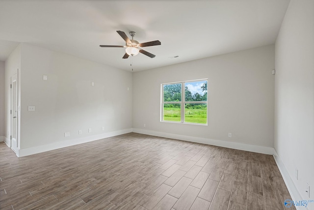 700 Magnolia Place Ln SW, Hartselle, AL 35640 - unfurnished room featuring wood finished floors, a ceiling fan, and baseboards
