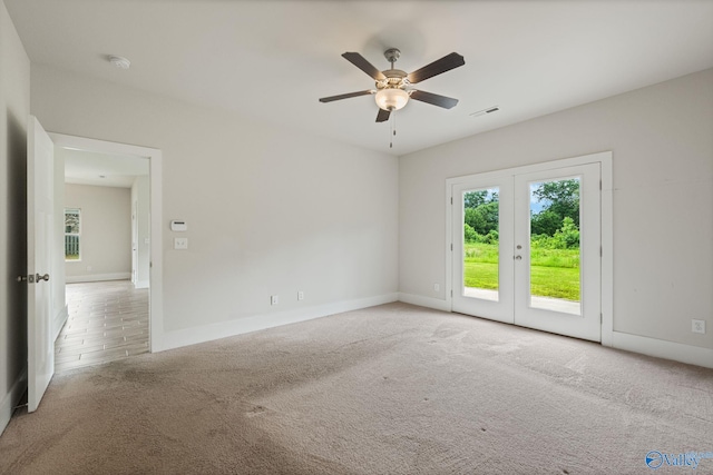 700 Magnolia Place Ln SW, Hartselle, AL 35640 - unfurnished room featuring carpet, ceiling fan, baseboards, french doors, and a smoke detector
