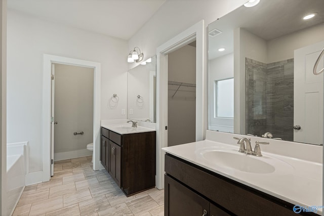 700 Magnolia Place Ln SW, Hartselle, AL 35640 - full bath featuring tiled shower, toilet, two vanities, recessed lighting, and a bath