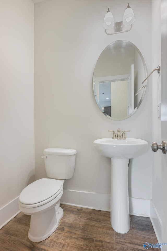 700 Magnolia Place Ln SW, Hartselle, AL 35640 - bathroom featuring baseboards, toilet, wood finished floors, and a sink