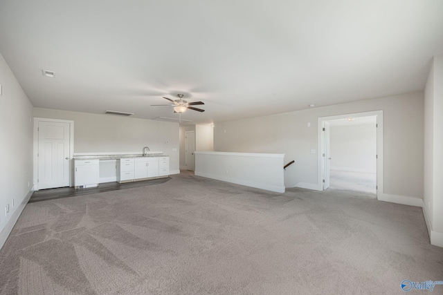 700 Magnolia Place Ln SW, Hartselle, AL 35640 - unfurnished living room with a sink, a ceiling fan, light colored carpet, and baseboards