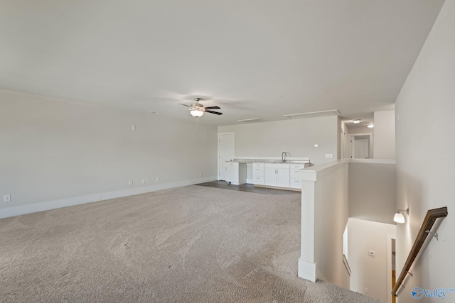 700 Magnolia Place Ln SW, Hartselle, AL 35640 - unfurnished living room with attic access, light colored carpet, ceiling fan, a sink, and baseboards