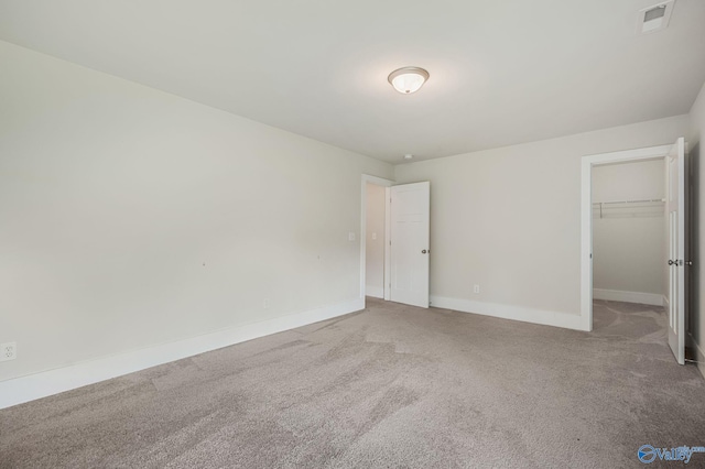 700 Magnolia Place Ln SW, Hartselle, AL 35640 - unfurnished bedroom with carpet flooring, baseboards, a spacious closet, and a closet