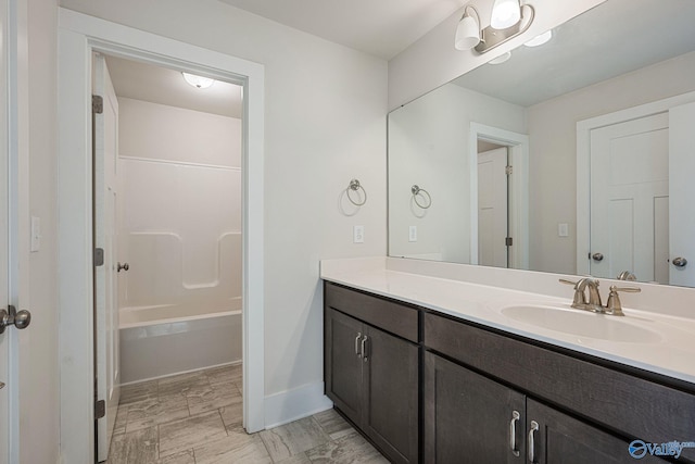 700 Magnolia Place Ln SW, Hartselle, AL 35640 - bathroom featuring vanity, baseboards, marble look tiles, and shower / tub combination
