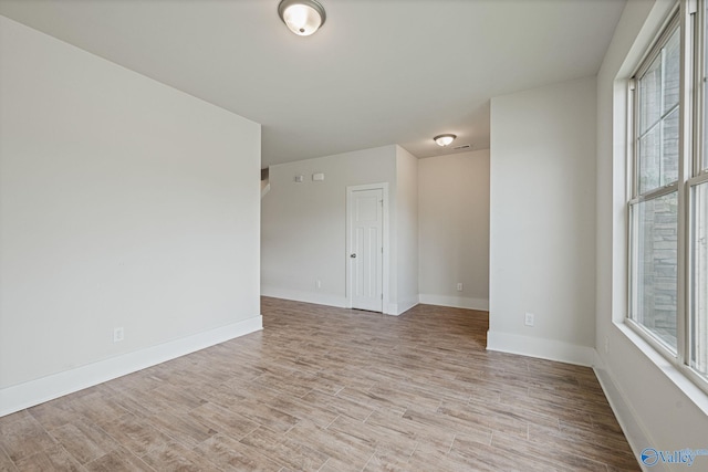 700 Magnolia Place Ln SW, Hartselle, AL 35640 - unfurnished room with healthy amount of natural light, light wood-style floors, and baseboards