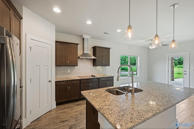 700 Magnolia Place Ln SW, Hartselle, AL 35640 - kitchen with a sink, wall chimney range hood, freestanding refrigerator, wood finished floors, and a ceiling fan