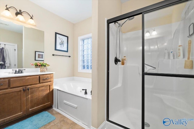 bathroom featuring vanity, shower with separate bathtub, and tile patterned flooring