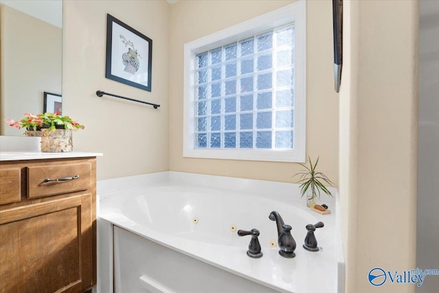 bathroom featuring vanity, a washtub, and a wealth of natural light