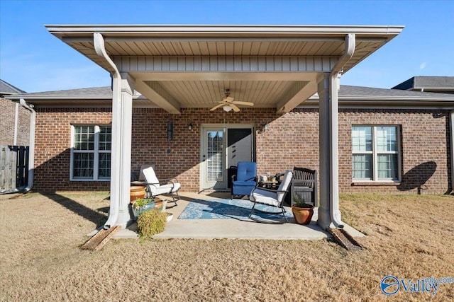 rear view of property with a patio area, ceiling fan, and a yard