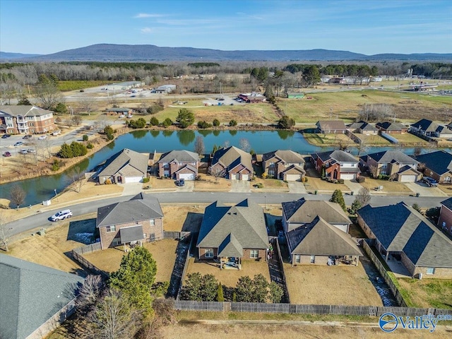 birds eye view of property featuring a water and mountain view