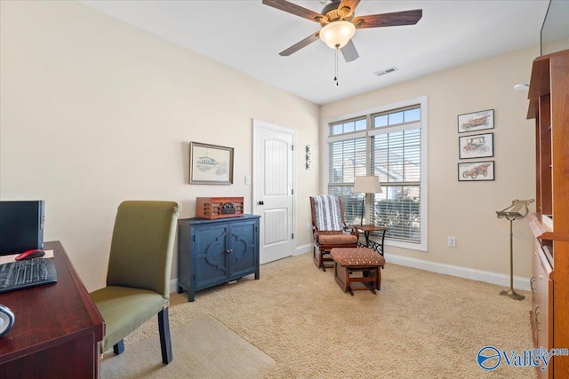 carpeted office featuring ceiling fan