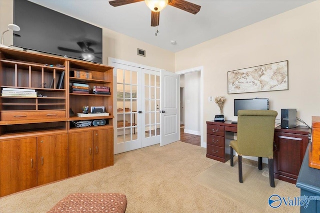 carpeted office space with ceiling fan and french doors