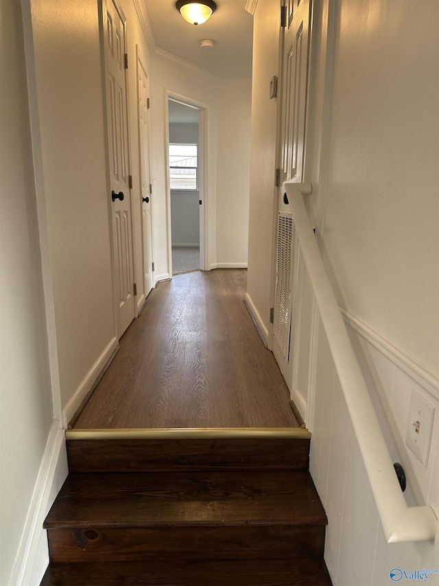 stairs featuring wood-type flooring and ornamental molding