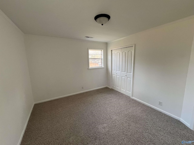 unfurnished bedroom featuring carpet flooring and a closet