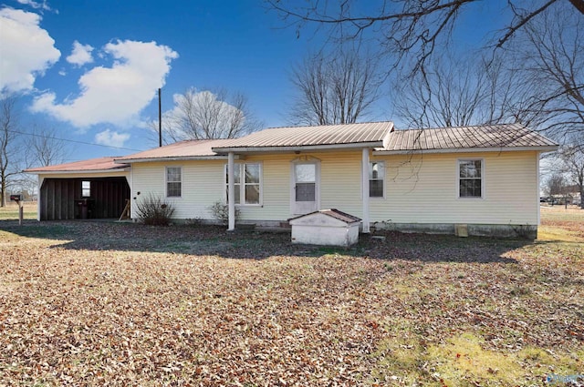 back of property featuring a carport