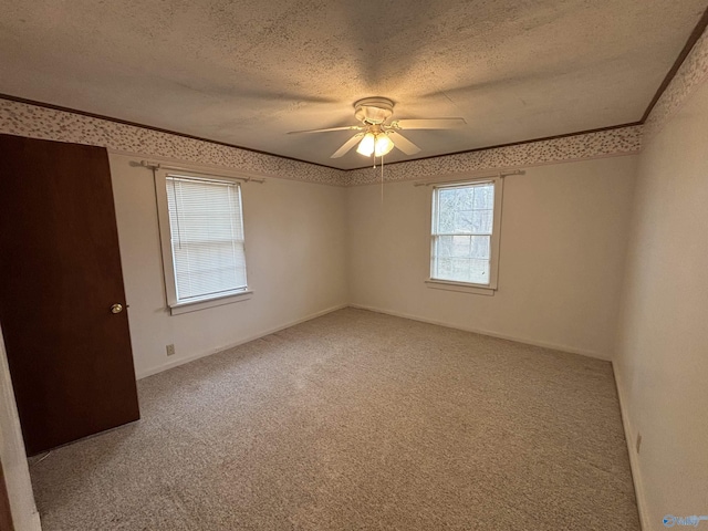 unfurnished room featuring crown molding, ceiling fan, carpet floors, and a textured ceiling