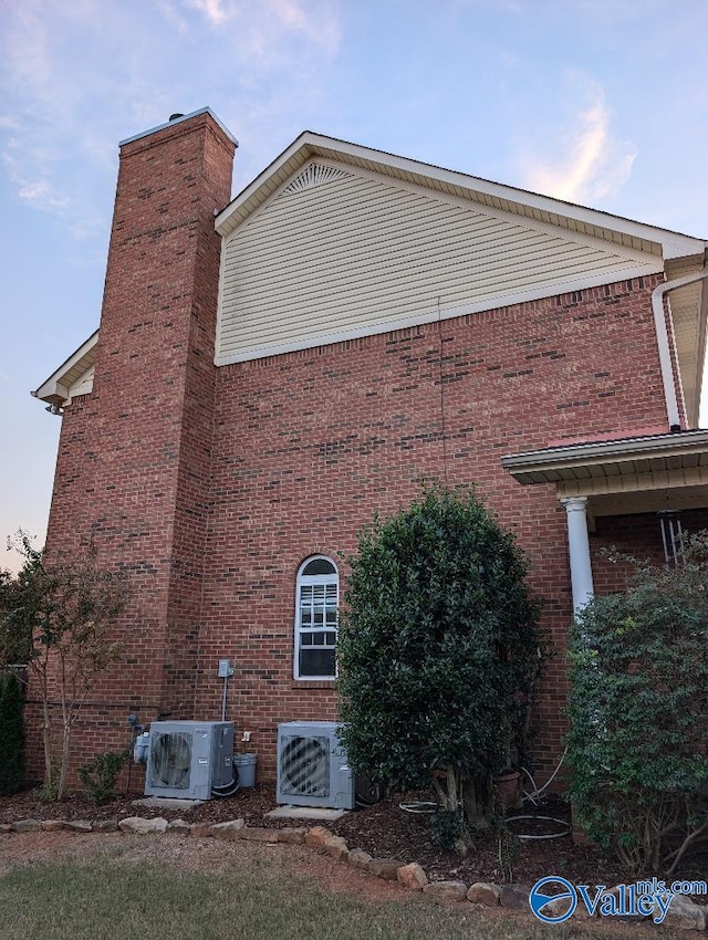 view of side of home featuring ac unit and cooling unit