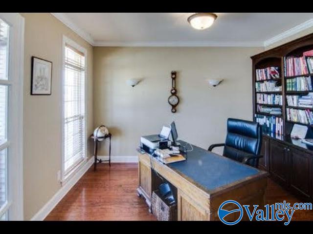 office area featuring dark hardwood / wood-style flooring and ornamental molding