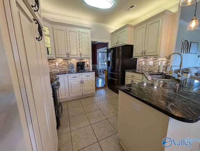 kitchen featuring sink, hanging light fixtures, light tile patterned floors, black fridge with ice dispenser, and kitchen peninsula