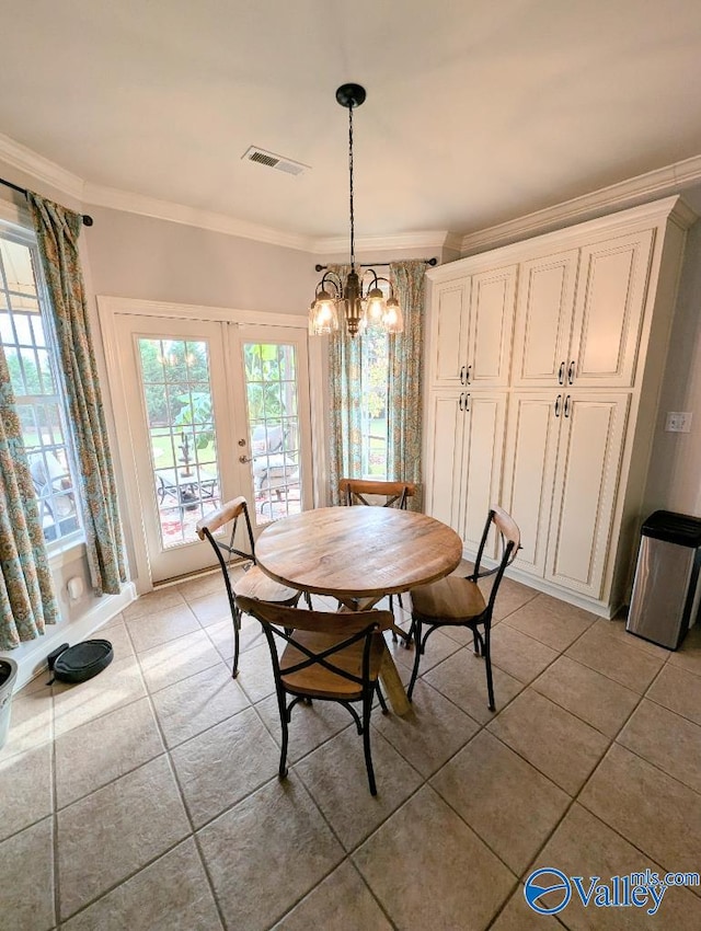 dining space with tile patterned flooring, french doors, and ornamental molding