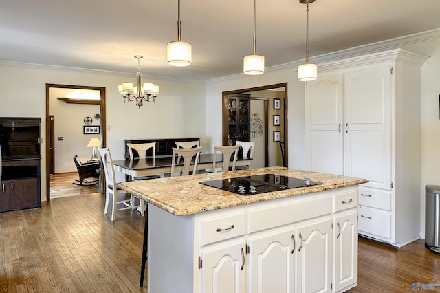 kitchen featuring crown molding, an inviting chandelier, white cabinets, black electric stovetop, and dark wood-style floors