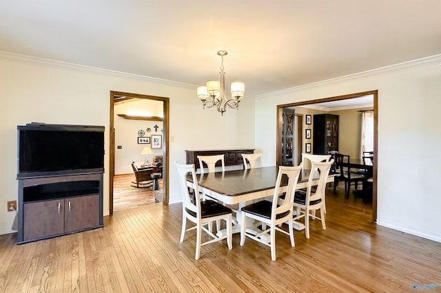 dining space featuring a chandelier, hardwood / wood-style floors, baseboards, and ornamental molding