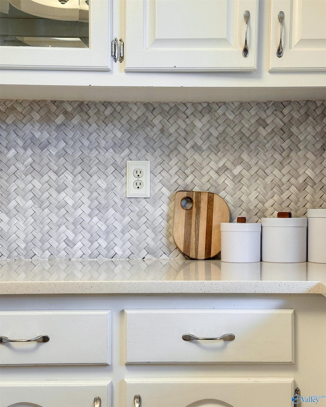 interior details featuring light countertops and white cabinets