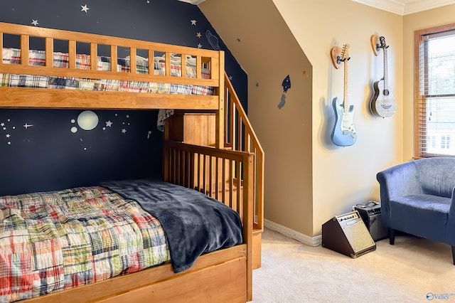 bedroom featuring crown molding, baseboards, and carpet