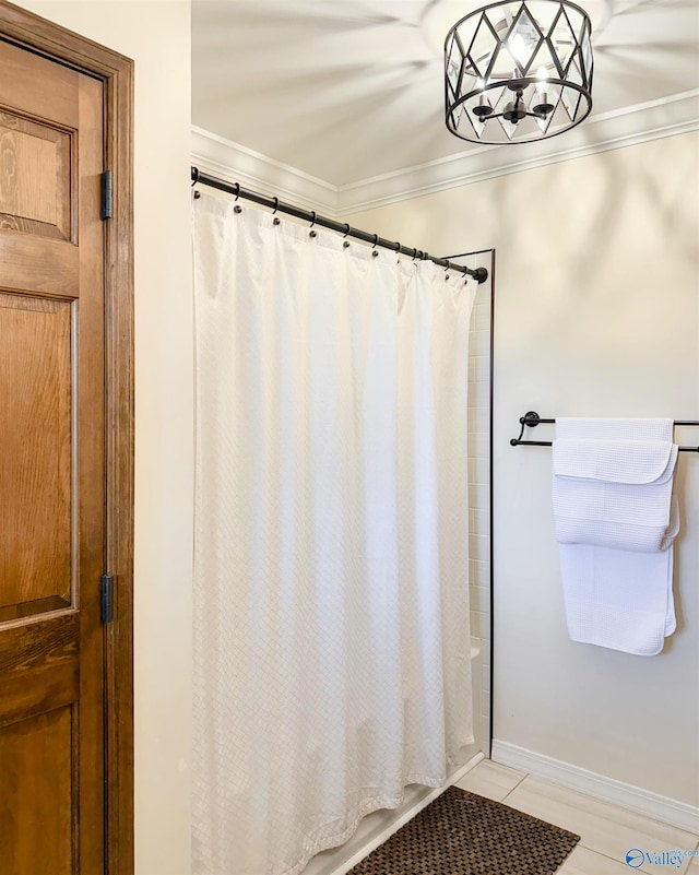 bathroom featuring shower / tub combo, crown molding, baseboards, and tile patterned floors