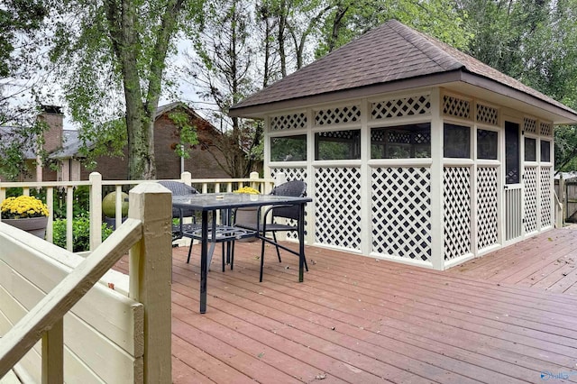 wooden deck featuring outdoor dining area
