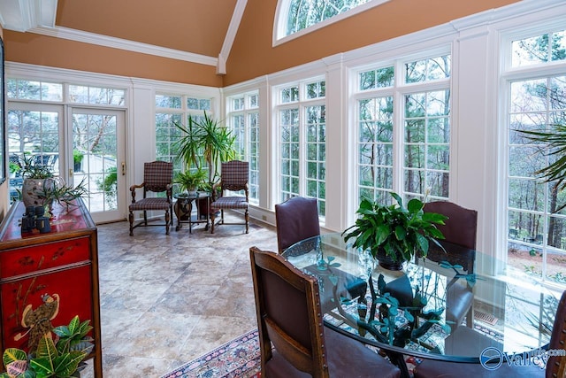 sunroom with high vaulted ceiling, crown molding, and plenty of natural light