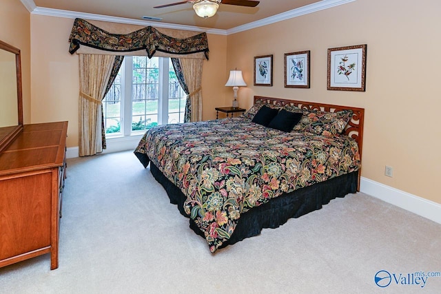 carpeted bedroom featuring ornamental molding, baseboards, ceiling fan, and visible vents