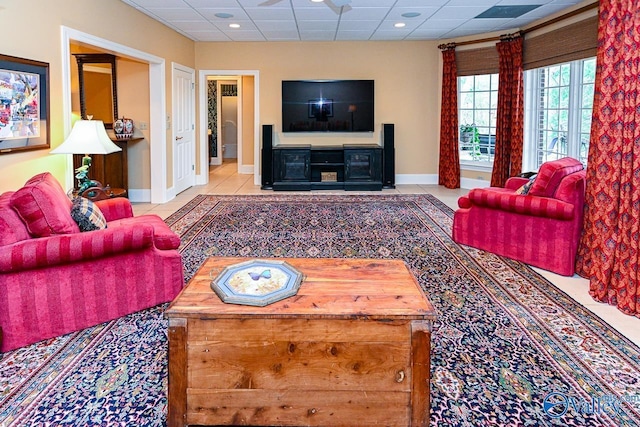 living room featuring baseboards, a drop ceiling, tile patterned floors, and recessed lighting