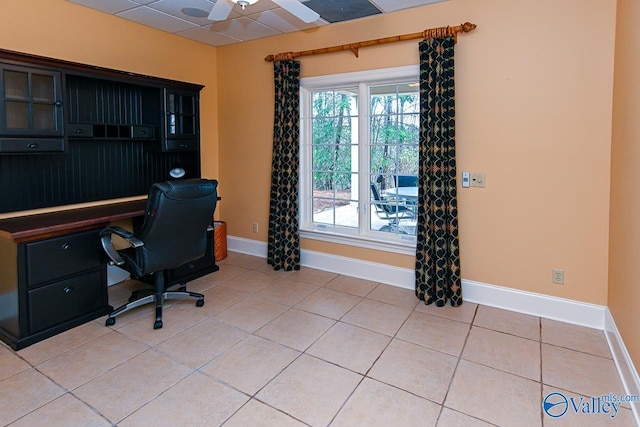 home office featuring light tile patterned floors, baseboards, ceiling fan, and a paneled ceiling