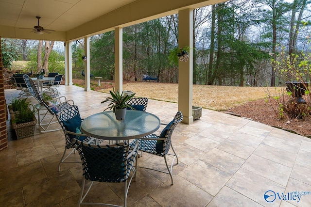 view of patio with outdoor dining area and a ceiling fan
